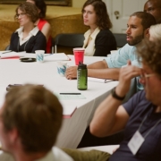 Participants and graduate students listening to a speaker session
